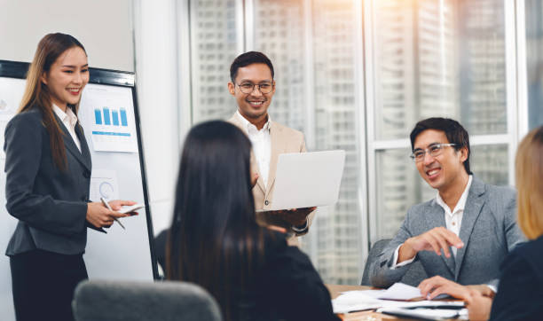 istock Smiling diverse colleagues gather in boardroom brainstorm discuss financial statistics together 2157033475