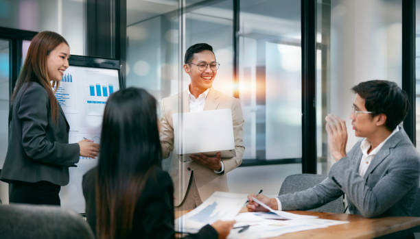 istock Executive business partners group discuss report at boardroom meeting table. 2157036040