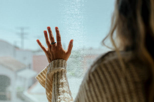 istock Woman staring out the window during a lockdown 2157039781