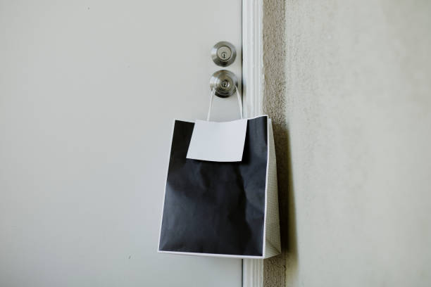 istock Black paper bag on a door knob during the coronavirus outbreak 2157040045