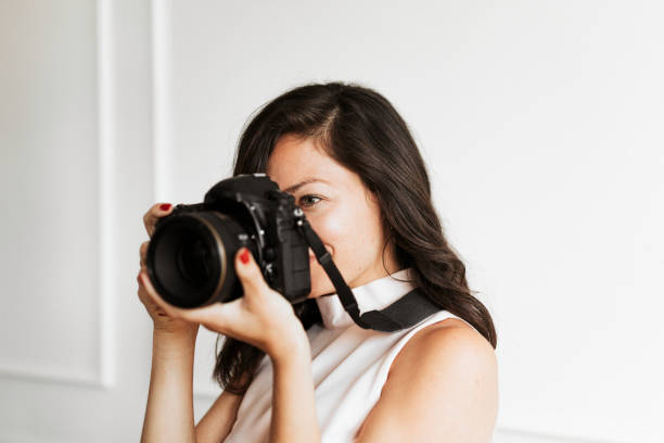 istock Female photographer holding digital camera 2157040562