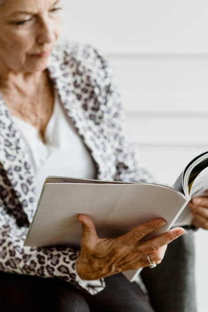 istock Old woman reading a magazine 2157040639