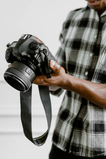 istock Male photographer holding a camera 2157040679