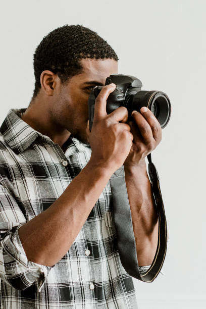 istock Male photographer holding a camera 2157040691
