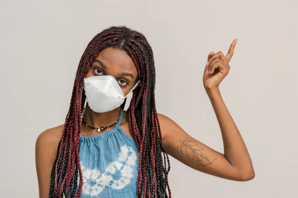 istock Black girl wearing an air pollution mask 2157041402