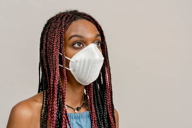 istock Black girl wearing an air pollution mask 2157041411