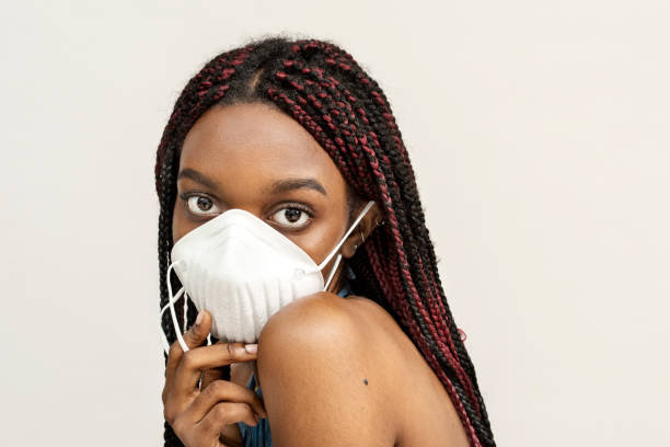 istock Black girl wearing an air pollution mask 2157041420