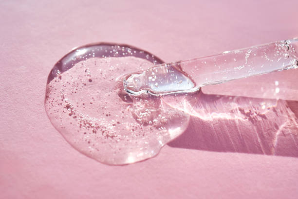 istock Pipette with serum shimmering in the sun on a pink background. 2157041618