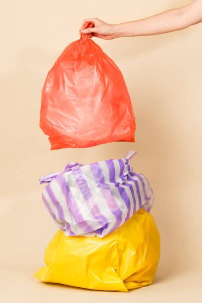 istock Colorful garbage bags isolated on yellow background 2157042741