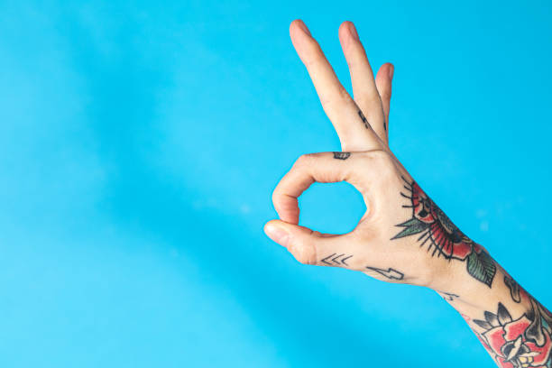 istock Feminine hand with tattooed making an ok sign 2157042840