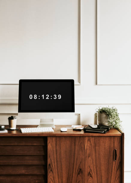 istock Computer by a daily planner on a wooden table 2157043588
