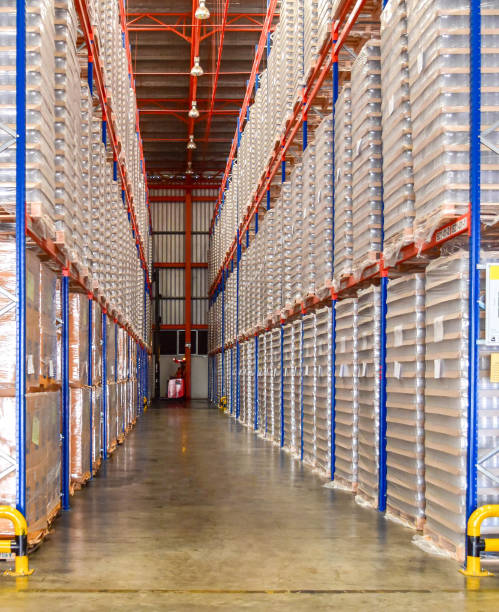 istock Large distribution warehouse interior, pallets, and boxes of cargo stack on row of high shelves. 2157043771