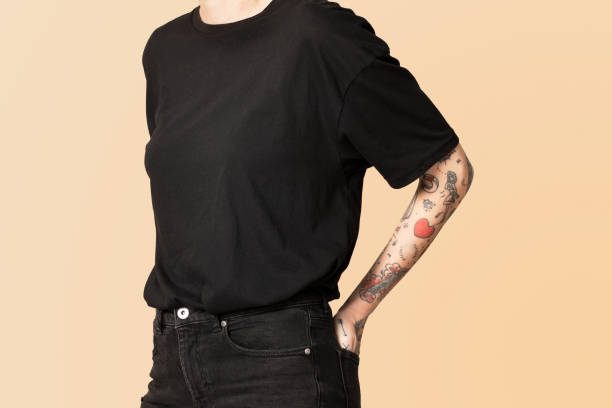 istock Model with tattoo in black T shirt and jeans 2157044108