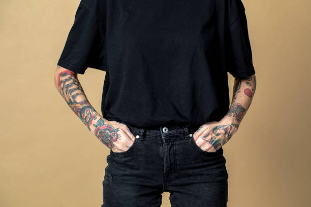 istock Tattooed model in black t shirt and jeans 2157044112