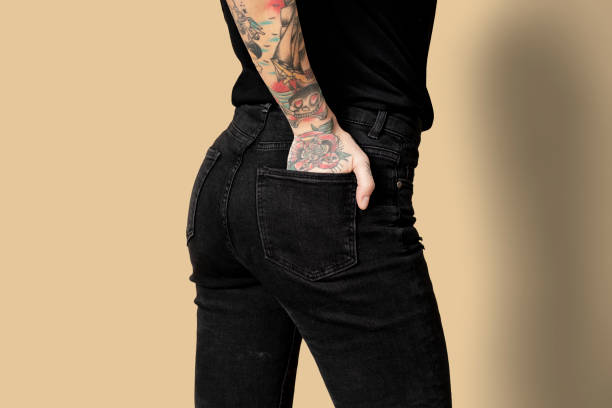 istock Model with tattoo in black T shirt and jeans 2157044155