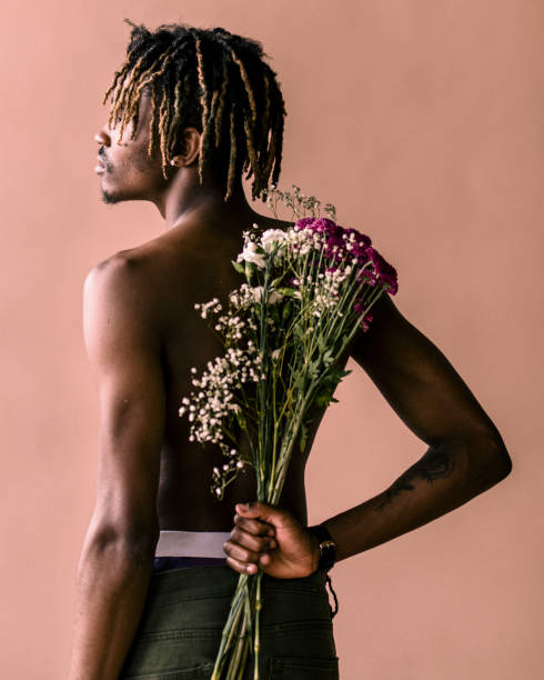istock Black man carrying a bouquet of flowers on his back 2157044549