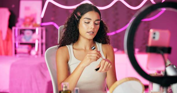 istock Woman, content creator and ring light for recording, cosmetics influencer and live streaming in studio. Talking, beauty and tutorial for foundation on social media, vlogger person for online webcam 2157048657