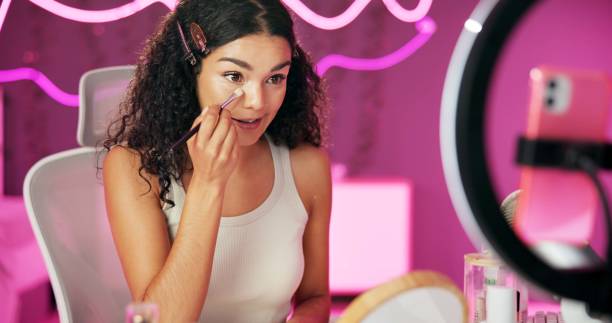 istock Woman, content creator and ring light for recording, cosmetics influencer and live streaming in studio. Talking, beauty and tutorial for foundation on social media, vlogger person for online webcam 2157048669