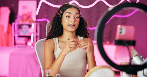 istock Woman, content creator and ring light for recording, cosmetics influencer and live streaming in studio. Talking, beauty and tutorial for foundation on social media, vlogger person for online webcam 2157048671
