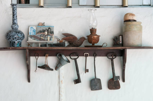 Traditional vintage metal cyprus tools and handcrafted objects hanging on white wall