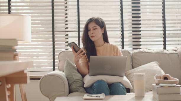 istock Asian woman using smartphone at home, working at home,virtual assistant 2157051292