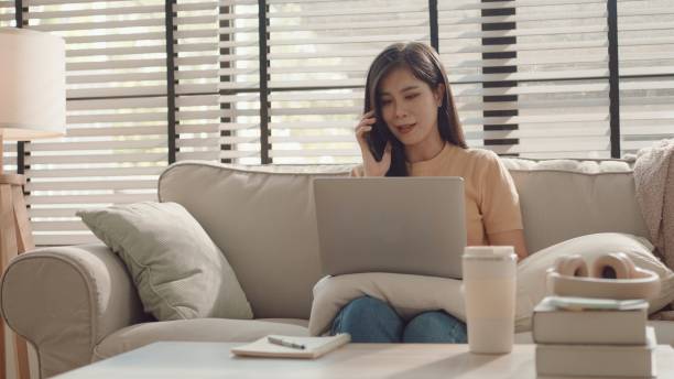 istock Asian woman using smartphone at home, working at home,virtual assistant 2157052059
