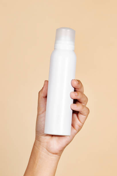 istock Hand holding a white spray bottle mockup 2157052763
