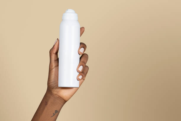 istock Black woman holding a white spray bottle 2157052769
