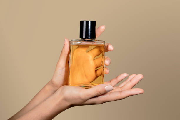 istock Woman holding an unlabeled perfume glass bottle 2157052803