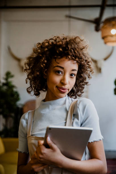 istock Cheerful woman holding a digital tablet in her arm 2157053863
