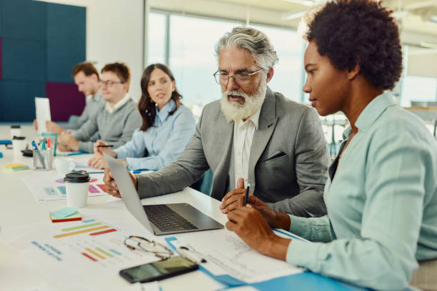istock Diverse business colleagues working on laptop in the office. 2157054632