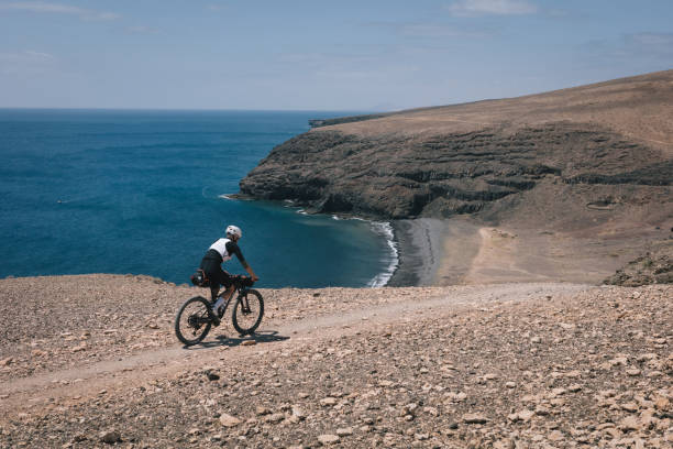 istock Bikepacker rides through desert landscape 2157055084