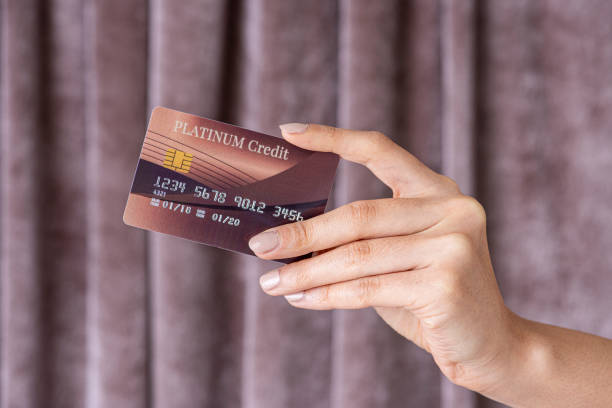 istock Feminine hand holding a credit card 2157055226