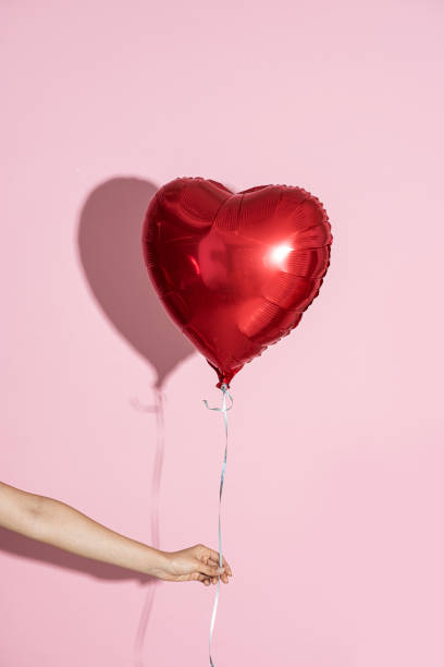 istock Heart shaped balloon on a pink background 2157055296