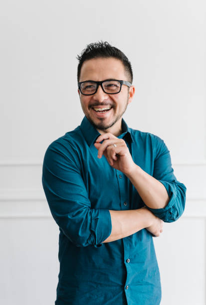 istock Young happy business man standing by a white wall 2157055861