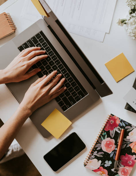 Female blogger working on her laptop at home