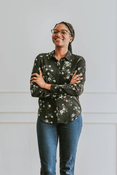 istock Happy empowering black woman standing by a white wall 2157056020