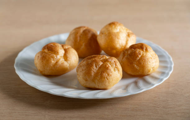istock Cream puffs placed on a plate at the table. 2157056281