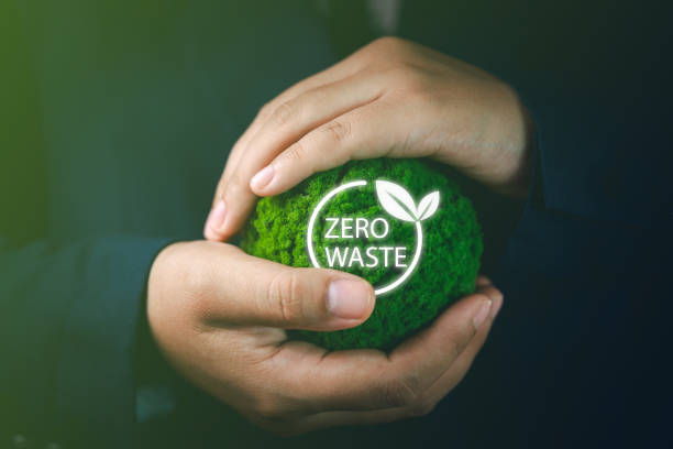 istock A businessman's hand holds a green simulated globe displaying a virtual screen focused on waste reduction and cutting carbon dioxide emissions to prevent greenhouse gases and protect nature 2157056860