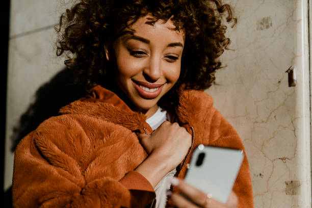 istock Cheerful black woman using her phone in downtown 2157056987