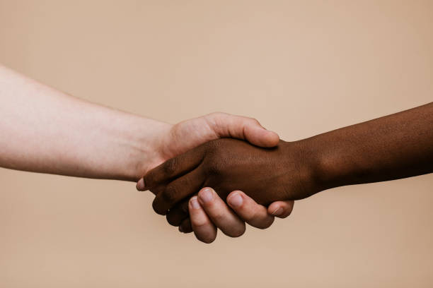 istock White hand shaking the black hand 2157057418