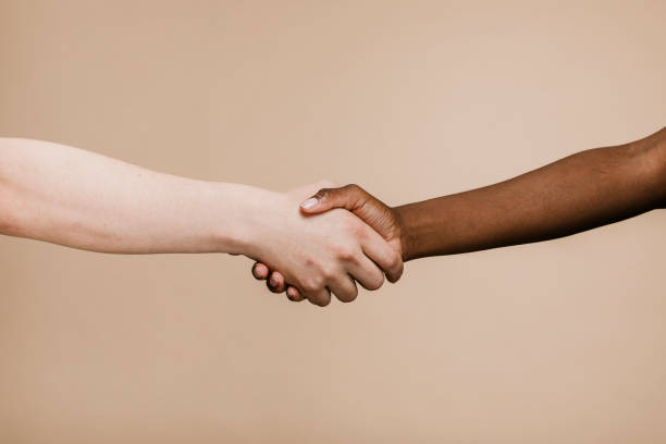 istock White hand shaking the black hand 2157057421