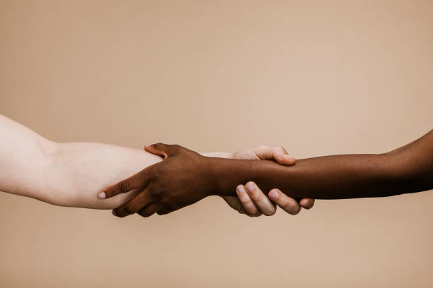 Black hand holding the white hand