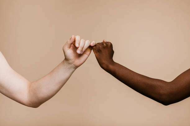 istock Black and white hands are making ap inky swear 2157057457