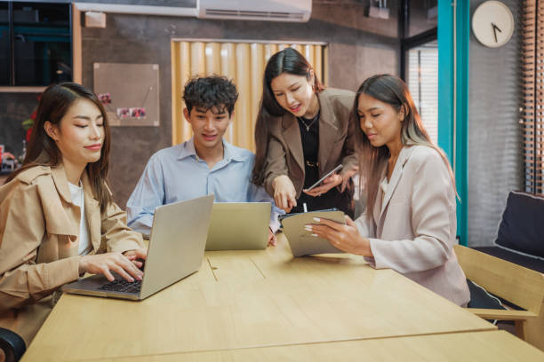 istock Working groups & Collaborations, Small group of young Asian people colleagues working together and discussing on new project at modern office 2157057589