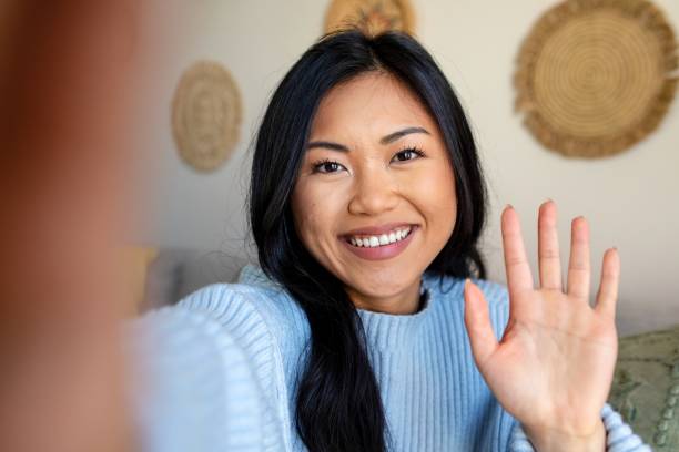 istock Woman saying hello, distance relationship through video call 2157059353