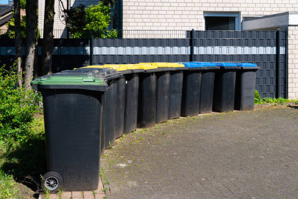 istock Plastic bins for separate waste collection are lined along the fence. 2157059931