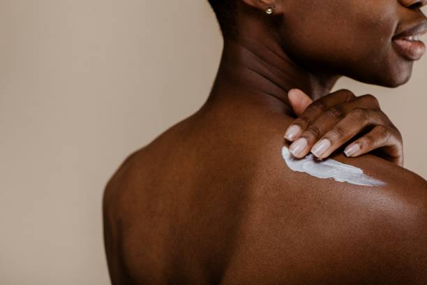 istock Black woman applying body cream 2157060043