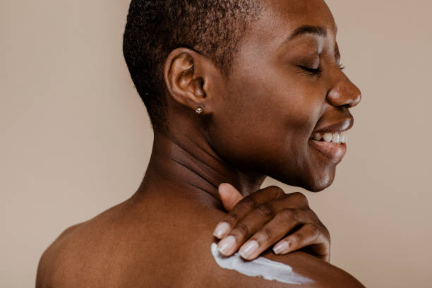istock Black woman applying body cream 2157060051