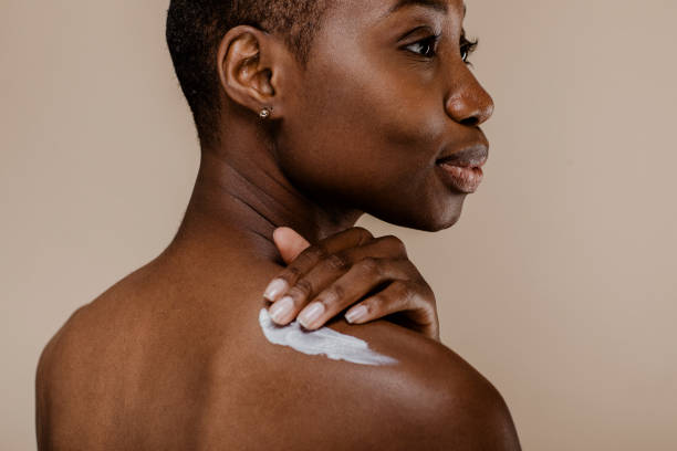 istock Black woman applying body cream 2157060054